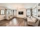 Bright living room with hardwood floors, neutral paint, large sectional, and flat screen TV at 4327 Wilson Peak Dr, Castle Rock, CO 80104