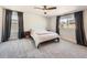 This main bedroom features a ceiling fan, carpeted floor and a large window with neighborhood views at 4327 Wilson Peak Dr, Castle Rock, CO 80104