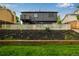 The backyard showcases a concrete retaining wall and landscaped garden beds, enhancing the outdoor living space at 19661 E Girard Ave, Aurora, CO 80013