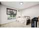 Bright bedroom features a day bed, large window, and neutral decor at 19661 E Girard Ave, Aurora, CO 80013