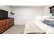 Well-lit bedroom with a wood dresser, sleek bedframe, and cozy carpets at 19661 E Girard Ave, Aurora, CO 80013