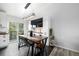 Inviting dining area with a wooden table, modern light fixture, and sliding door to the outside at 19661 E Girard Ave, Aurora, CO 80013