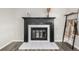 Close-up of the fireplace with a black mantel and decorative accents at 19661 E Girard Ave, Aurora, CO 80013