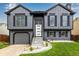 Beautiful two-story home with gray siding, black shutters, and well manicured lawn offering great curb appeal at 19661 E Girard Ave, Aurora, CO 80013