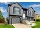 Beautiful two-story home with gray siding, black shutters, and well manicured lawn and charming appeal at 19661 E Girard Ave, Aurora, CO 80013