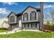 Two-story home with gray siding and black trim and shutters sits on a green lawn for great curb appeal at 19661 E Girard Ave, Aurora, CO 80013