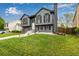 Attractive two-story home with gray siding and black shutters and trim, a nice front lawn, and inviting curb appeal at 19661 E Girard Ave, Aurora, CO 80013