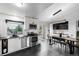 Modern kitchen featuring white cabinets, stainless steel appliances, subway tile, and a dining area at 19661 E Girard Ave, Aurora, CO 80013