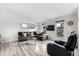 Bright living room featuring gray walls, laminate flooring, and comfortable leather seating with lots of natural light at 19661 E Girard Ave, Aurora, CO 80013