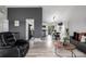 View of a sleek, modern living room that transitions into the open concept dining and kitchen space at 19661 E Girard Ave, Aurora, CO 80013