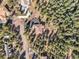 Aerial shot of a secluded home nestled among lush green trees at 20957 Horse Bit Way, Morrison, CO 80465