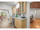 Wet bar with built-in cabinets, wine cooler, and views to both the kitchen and living areas at 20957 Horse Bit Way, Morrison, CO 80465