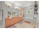 Bright bathroom with double vanity, tub, and light tile flooring at 20957 Horse Bit Way, Morrison, CO 80465