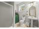 Cozy bathroom features a pedestal sink and charming green dresser at 20957 Horse Bit Way, Morrison, CO 80465
