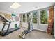 Bright exercise room with large windows offering scenic views and multiple exercise machines at 20957 Horse Bit Way, Morrison, CO 80465