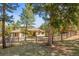 Charming home surrounded by mature trees and a wooden fence in a serene, wooded setting at 20957 Horse Bit Way, Morrison, CO 80465
