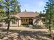 Charming single-story home featuring a well-maintained lawn and mature trees in a tranquil and picturesque setting at 20957 Horse Bit Way, Morrison, CO 80465