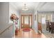 Inviting foyer featuring hardwood floors, decorative front door, and elegant chandelier, offering a warm welcome at 20957 Horse Bit Way, Morrison, CO 80465