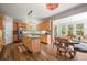Charming eat-in kitchen features wood floors, a center island and stainless steel appliances at 20957 Horse Bit Way, Morrison, CO 80465