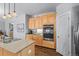 This kitchen has stainless steel appliances, light wood cabinets, and a granite countertop at 20957 Horse Bit Way, Morrison, CO 80465