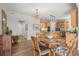 Bright eat-in kitchen area featuring wood floors, stainless steel appliances, and a stylish hanging light fixture at 20957 Horse Bit Way, Morrison, CO 80465