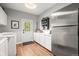 Functional laundry room with modern appliances, ample counter space, and convenient access to the backyard at 20957 Horse Bit Way, Morrison, CO 80465