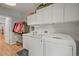 Well-equipped laundry room with modern washer and dryer units, shelving, and a convenient sink at 20957 Horse Bit Way, Morrison, CO 80465