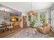 Cozy sitting area with large windows, comfortable seating, and view into the adjacent kitchen at 20957 Horse Bit Way, Morrison, CO 80465