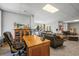 Spacious living room features a comfortable seating area and an oak desk and display case at 20957 Horse Bit Way, Morrison, CO 80465