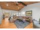 Spacious living room with vaulted wood ceilings, hardwood floors and a large sectional couch at 20957 Horse Bit Way, Morrison, CO 80465