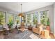 Inviting sunroom with large windows providing natural light and scenic views of the surrounding trees at 20957 Horse Bit Way, Morrison, CO 80465