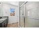 Bathroom with double sinks, white tile shower and a view from the window at 5367 Spring Ridge Trl, Castle Rock, CO 80104