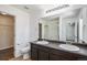 Bathroom with double sink vanity, large mirror, and a shower with glass doors at 5367 Spring Ridge Trl, Castle Rock, CO 80104