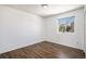 Bright bedroom featuring wood-look flooring and a sunny window for natural light at 5367 Spring Ridge Trl, Castle Rock, CO 80104