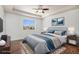 Comfortable bedroom with a tray ceiling, a large window, and a ceiling fan at 5367 Spring Ridge Trl, Castle Rock, CO 80104