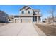 Charming two-story home featuring a three-car garage, landscaped front yard, and welcoming front porch at 5367 Spring Ridge Trl, Castle Rock, CO 80104