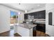 Modern eat-in kitchen with dark cabinets, granite countertops, and stainless steel appliances at 5367 Spring Ridge Trl, Castle Rock, CO 80104