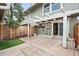 Covered back patio with privacy fence, an outdoor AC unit, and access to home at 10311 E Evans Ave # 132, Aurora, CO 80247