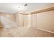 Finished basement with beige carpet, interior doors, and neutral walls. Ready for renovation at 10311 E Evans Ave # 132, Aurora, CO 80247