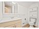 Bathroom with a vanity, mirror, toilet, and wall storage with fresh white paint at 10311 E Evans Ave # 132, Aurora, CO 80247