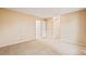 Bedroom with carpet and neutral walls, open door to the home at 10311 E Evans Ave # 132, Aurora, CO 80247