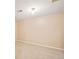 Bedroom boasts neutral carpet, a single light fixture, and an electrical outlet at 10311 E Evans Ave # 132, Aurora, CO 80247
