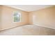 Spacious bedroom with carpet and neutral walls, with a window providing natural light at 10311 E Evans Ave # 132, Aurora, CO 80247