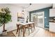 Dining area with access to outdoor patio, white table, stylish chairs, and plenty of natural light at 10311 E Evans Ave # 132, Aurora, CO 80247