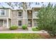 Charming townhouse with stone accents, lush landscaping, and a well-maintained lawn at 10311 E Evans Ave # 132, Aurora, CO 80247