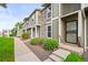 View of the exterior featuring stone accents and a tidy landscaped front yard at 10311 E Evans Ave # 132, Aurora, CO 80247