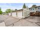 Exterior shot of garages, each with white doors, siding, and a private storage closet at 10311 E Evans Ave # 132, Aurora, CO 80247