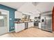 Updated kitchen featuring white cabinetry, stainless steel appliances, and light wood floors at 10311 E Evans Ave # 132, Aurora, CO 80247