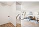 Open floor plan living room view showing a staircase, mirrored wall, and decor at 10311 E Evans Ave # 132, Aurora, CO 80247