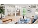 Bright living room with a fireplace, a large window, light wood floors and contemporary decor at 10311 E Evans Ave # 132, Aurora, CO 80247